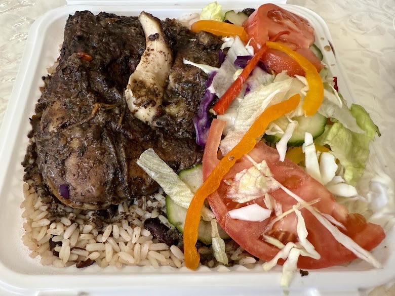 Jerk chicken over rice and peas